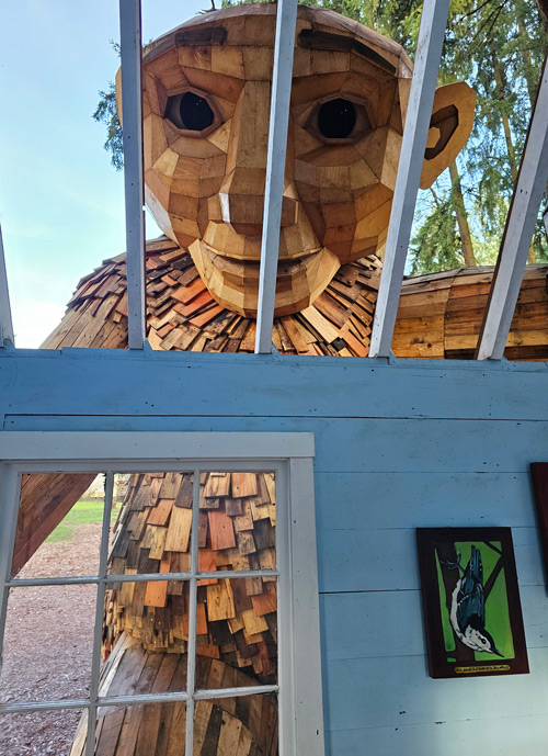 Troll Ole Bolle peers inside a small cottage at Nordia Center in Portland, Oregon